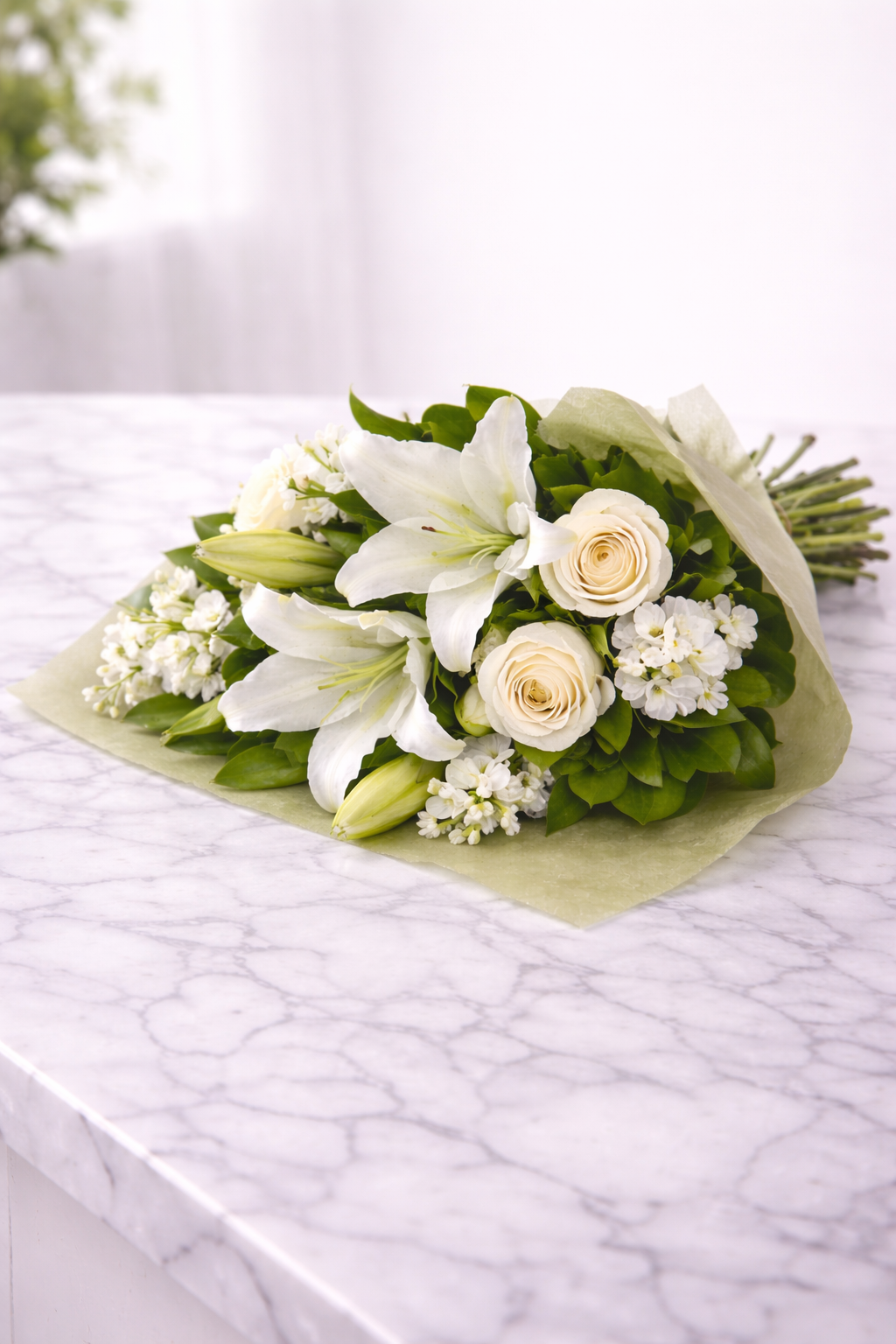 Bouquet of white and green flowers on a marble surface