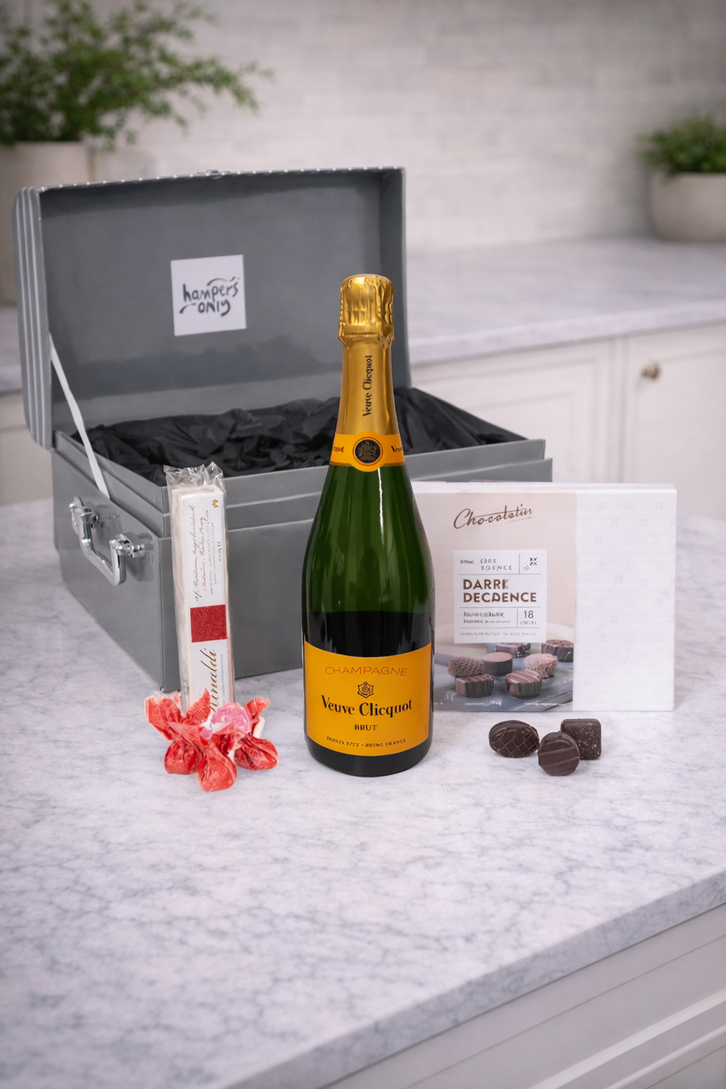Veuve Clicquot champagne bottle with chocolates on a countertop